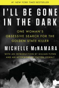 The cover of the book "i'll be gone in the dark: one woman's obsessive search for the golden state killer" by michelle mcnamara, hailed as a new york times bestseller, with an introduction by gillian flynn and an afterword by patton oswalt. the cover features a stark contrast of yellow and black with distressed white lettering.