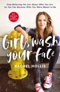 A confident woman sitting on a curb next to a yellow fire hydrant, featured on the cover of "girl, wash your face" by rachel hollis.