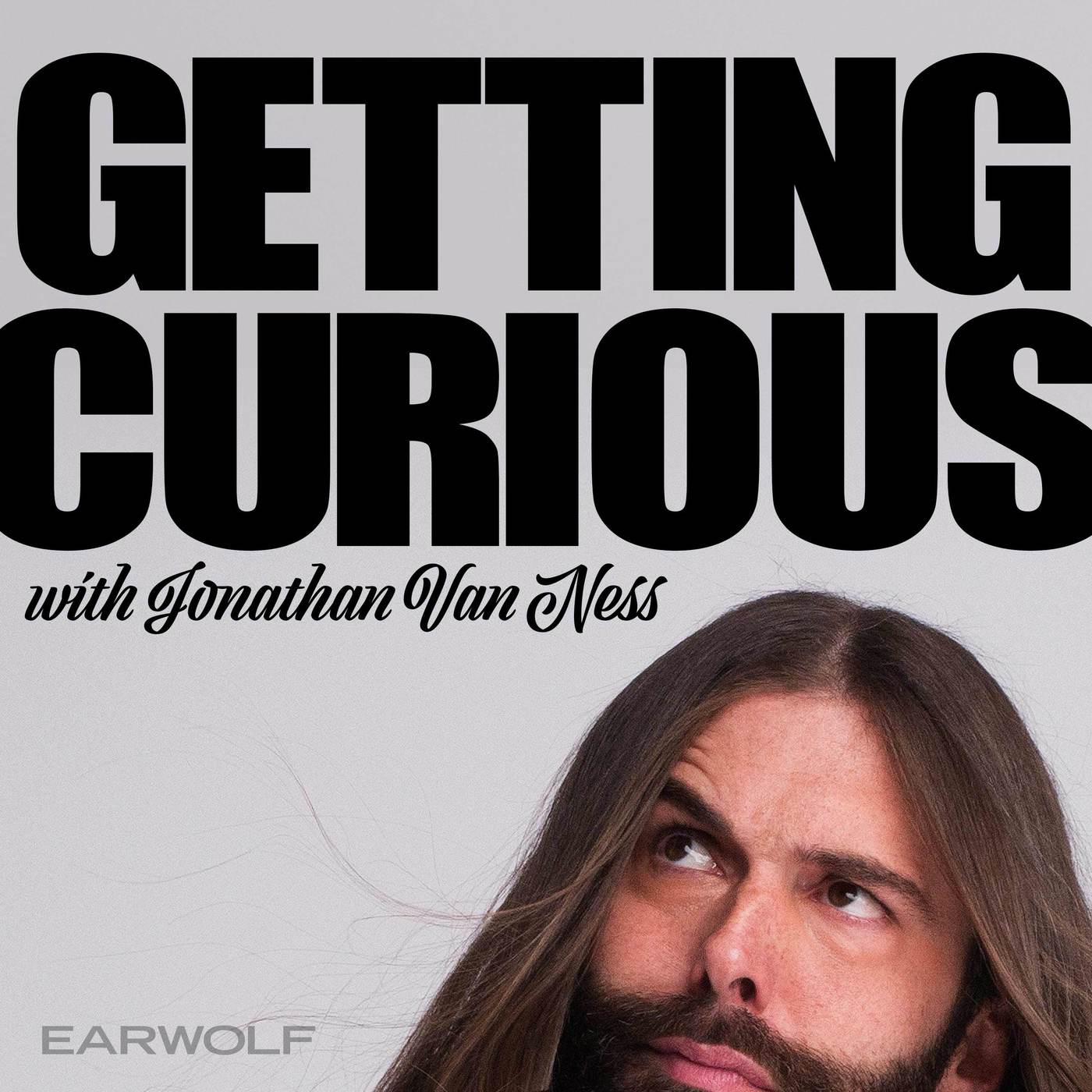 Promotional graphic for 'getting curious with jonathan van ness,' featuring the contemplative host with an iconic long hair and beard, representing a podcast filled with curiosity and discovery.