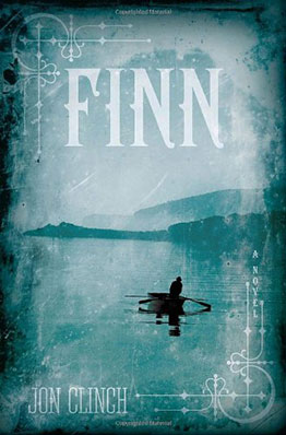 A solitary figure paddles a canoe across a misty, serene lake under an overcast sky, evoking a sense of calm solitude, on the cover of jon clinch's novel "finn.