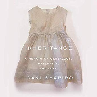 The image displays the cover of a book titled "inheritance: a memoir of genealogy, paternity, and love" by dani shapiro. the cover art features a simple child's dress set against a plain, light background, suggesting themes of family, childhood, and identity.