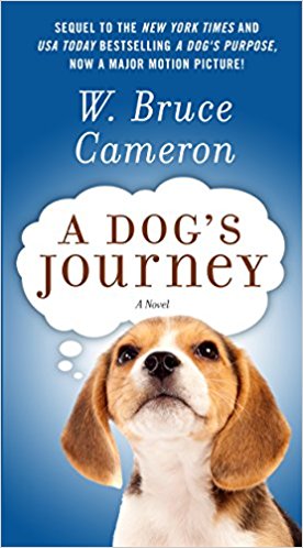 A cute beagle puppy looking upward with hopeful eyes in front of a blue sky background on the cover of w. bruce cameron's novel "a dog's journey," which is indicated as the sequel to the new york times and usa today bestselling book and major motion picture "a dog's purpose.