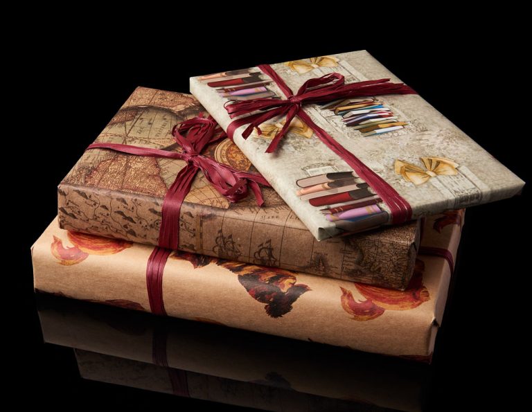Two elegantly wrapped gifts adorned with ribbons and unique paper designs, suggesting a sense of mystery and anticipation for the contents within.