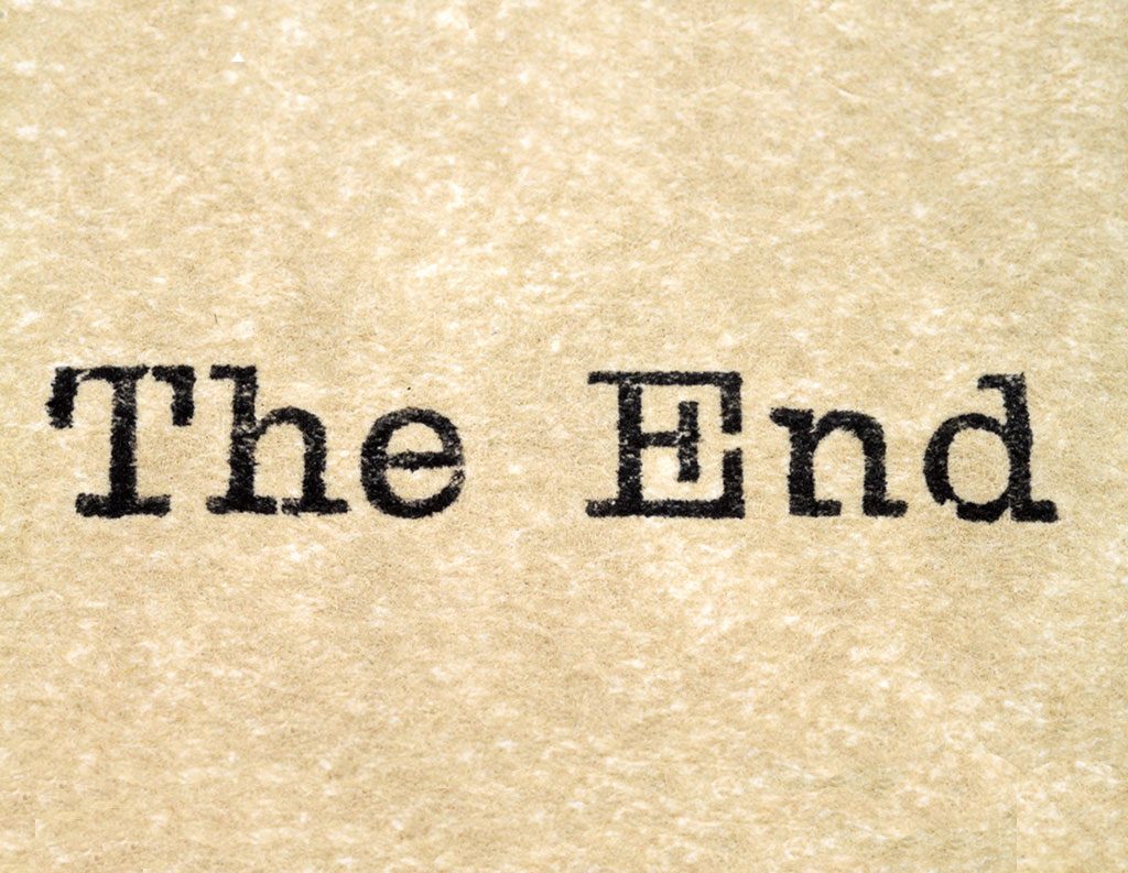 The end" written in classic typeface on textured paper, signifying conclusion.