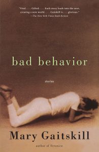 A book cover for "bad behavior" by mary gaitskill, featuring a vintage style image of a person lying on their stomach, seemingly suspended in motion or falling, set against a warm sepia-toned background. the new york times book review praises the author as "vital...gifted..." with each story leading into the next, declaring the work "glorious.