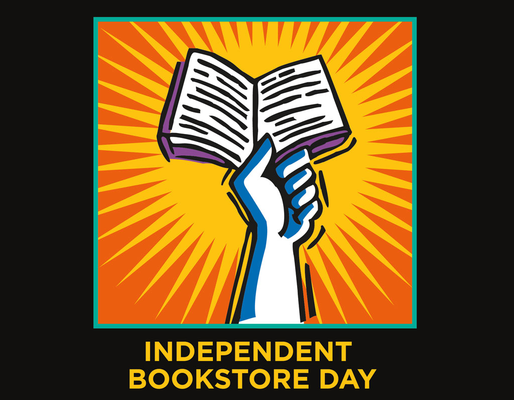 A hand holding aloft an open book with radiating light, symbolizing the celebration and support of independent bookstore day.