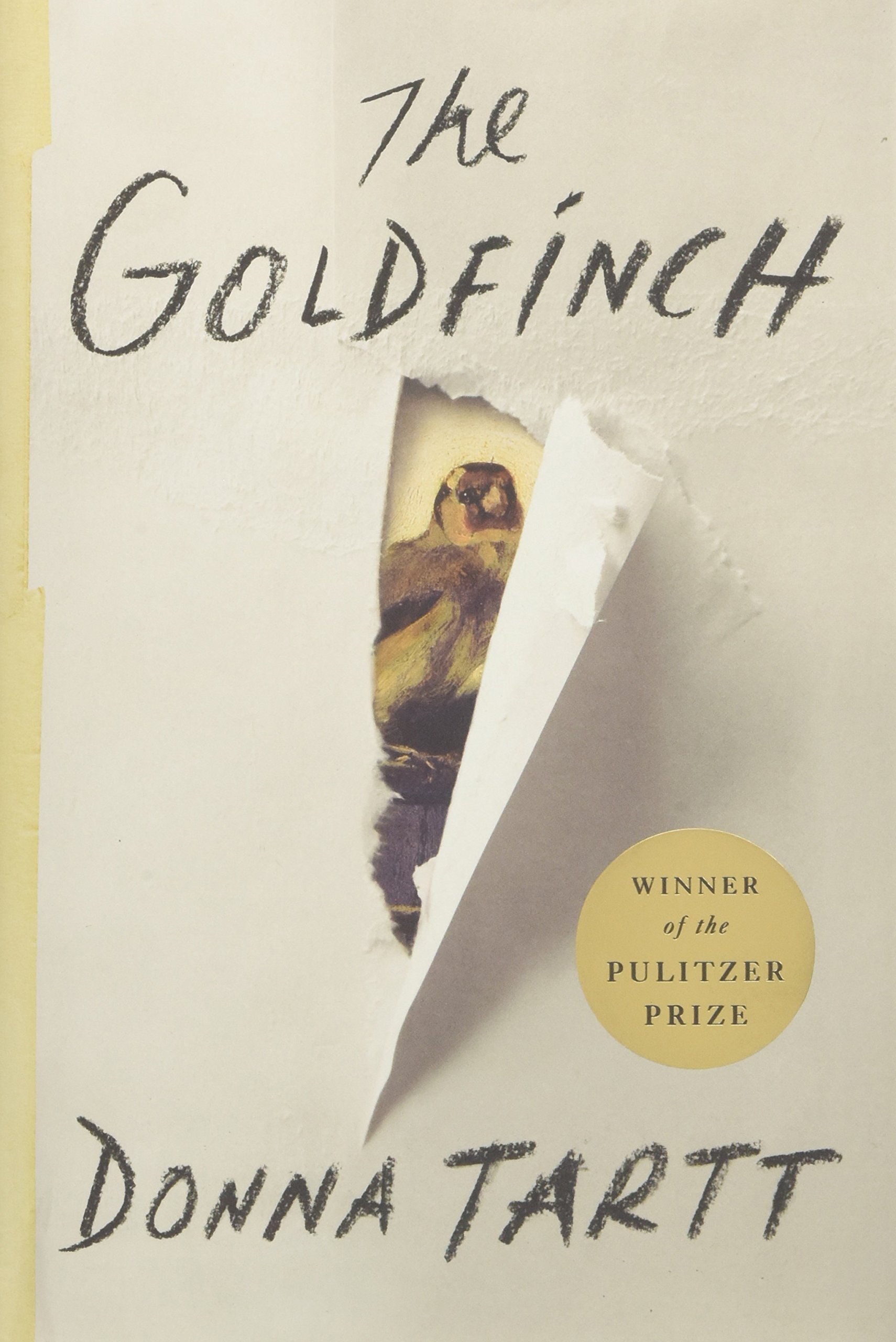 A torn cover of "the goldfinch" by donna tartt, revealing a painting of a bird, with a label indicating it's a pulitzer prize winner.