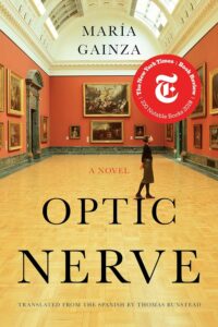 A woman walks through an art gallery; cover of "Optic Nerve" by María Gainza, translated by Thomas Bunstead.