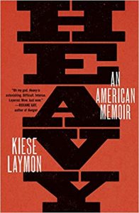 The image displays the cover of a book titled "heavy: an american memoir" by kiese laymon. the cover art is abstract and geometric, predominantly in black and red tones, creating a bold and impactful visual design.