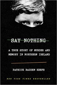 Intense gaze peeking through darkness on the cover of 'say nothing: a true story of murder and memory in northern ireland' by patrick radden keefe.