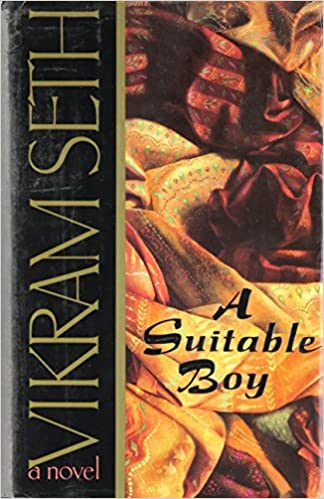 A paperback edition of 'a suitable boy' by vikram seth, featuring a colorful cover with intricate fabric designs.