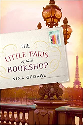 A novel titled 'the little paris bookshop' by nina george, set against a dreamy parisian backdrop featuring the eiffel tower and ornate street lamps.