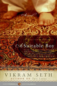 Book cover of "A Suitable Boy" by Vikram Seth, featuring feet on a patterned red and gold carpet.