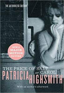 A cover of patricia highsmith's book "the price of salt, or carol," featuring the image of a contemplative woman resting her chin on her hand, with a backdrop of books. the cover also notes that this edition is an authorized one and that there is a major motion picture based on the novel. an author's afterword is included in this edition.