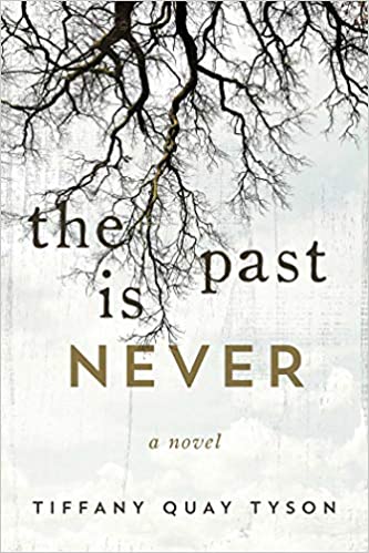 A book cover with bare tree branches against a pale background and the title "the past is never" in large, bold lettering, signifying a sense of mystery or reflection, with the author's name, tiffany quay tyson, beneath.