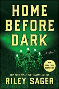 Cover of the suspense novel 'home before dark' by riley sager, featuring a shadowy chandelier against a haunting green background.