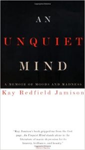 Cover of the book 'an unquiet mind: a memoir of moods and madness' by kay redfield jamison displaying the title and author's name in contrasting white and red font overlaid on a black background.