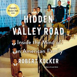 Book cover of 'hidden valley road: inside the mind of an american family' by robert kolker, featured in oprah's book club 2020, depicting a vintage family portrait with members of varying ages positioned on a staircase, highlighting the narrative's exploration of family dynamics and mental illness.