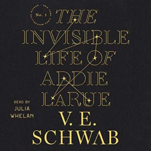 An audiobook cover for "the invisible life of addie larue" by v.e. schwab, read by julia whelan, featuring golden text on a dark background.