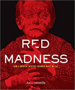 Cover of 'red madness' featuring a haunting, red-tinted image of a young child's face, symbolizing the historical medical mystery within.