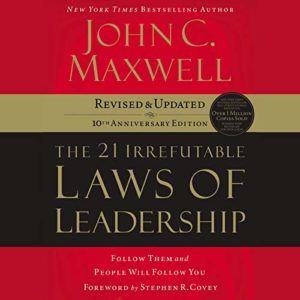 Cover of john c. maxwell's book "the 21 irrefutable laws of leadership" featuring a bold red and black design with gold lettering, celebrating the 10th anniversary update version and highlighting its status as a new york times bestseller.
