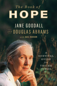 A contemplative woman looking into the distance on the cover of "the book of hope" by jane goodall and douglas abrams with gail hudson.