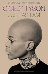 A profile view of a woman with a poised and contemplative expression, captured in monochrome, graces the cover of her memoir titled "just as i am.