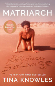 A woman kneels on a beach by writing in sand; the book cover reads "Matriarch" by Tina Knowles.