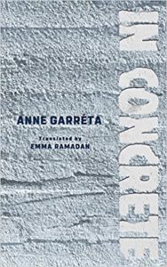 Cover of a book titled "in concrete" by anne garreta, translated by emma ramadan, featuring a textured gray background with the title text running vertically along the spine.
