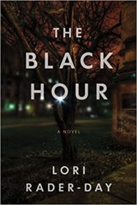 The image is the cover of a book titled "the black hour," a novel by lori rader-day. the cover depicts a dark, moody scene with a leafless tree at the center, set against a backdrop of shadowy buildings that could suggest an academic or institutional setting. the atmosphere is eerie, hinting at mystery or suspense contained within the pages of the book.