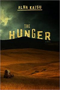 A hauntingly dark prairie under a cloudy sky with the title "the hunger" by alma katsu displayed prominently, suggesting a tale of suspense and mystery.