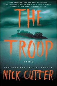 The troop" by nick cutter, a chilling horror novel cover featuring eerie forest imagery and a bold, unsettling title font that hints at the terror within its pages.