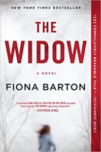 A book cover for the novel "the widow" which is a new york times bestseller, with high praise quoted from stephen king, comparing it favorably to 'gone girl' and 'the girl on the train'. the cover design features a stark, wintery tree landscape with a blurred figure in the distance, conveying a sense of mystery and suspense.