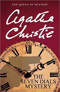 A book cover featuring the title "agatha christie - the queen of mystery: the seven dials mystery," with the image of a clock face and silhouettes suggesting a mysterious and thrilling narrative.
