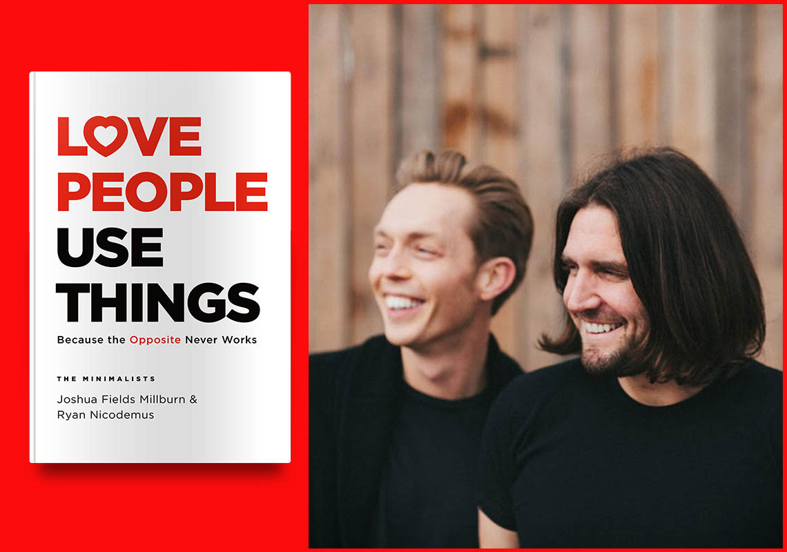 Two men sharing a cheerful moment together with a book titled "love people use things" by the minimalists, joshua fields millburn & ryan nicodemus, in the foreground.