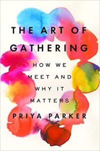 A colorful book cover featuring vibrant watercolor blots in shades of blue, pink, and yellow, with the title "the art of gathering: how we meet and why it matters" by priya parker prominently displayed in bold text.