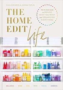 A book cover for "the home edit life" by clea shearer and joanna teplin, featuring an organized array of household items demonstrating the art of tidying and organizing different aspects of home and life.