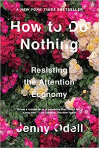 A book cover with the title "how to do nothing: resisting the attention economy" by jenny odell, surrounded by a floral background.