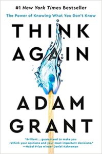Flame of reconsideration: the cover of 'think again' by adam grant, challenging readers to reevaluate their beliefs and decision-making processes.