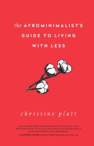 Simplistic elegance: a book cover for "the afrominimalist’s guide to living with less" that combines minimalistic design with a touch of natural beauty, showcasing three cotton blooms against a bold red background.