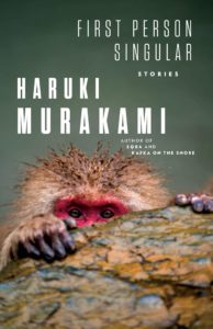 A japanese macaque gazes contemplatively from behind a rock, partially hidden, on the cover of haruki murakami's book "first person singular.