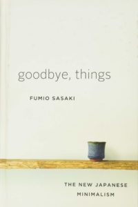 A book cover with a simple design titled "goodbye, things" by fumio sasaki, highlighting the concept of "the new japanese minimalism" with a solitary cup on a wooden shelf representing simplicity.