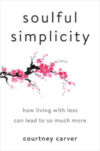 A minimalist book cover design featuring the title "soulful simplicity" in lowercase, with the subtitle "how living with less can lead to so much more" beneath it. an elegant graphic of a black branch with pink cherry blossoms stretches from the bottom left corner into the center, adding a touch of natural beauty that embodies the book's theme. the author's name, "courtney carver," is at the bottom. the background is plain white, emphasizing the simplicity suggested by the title.