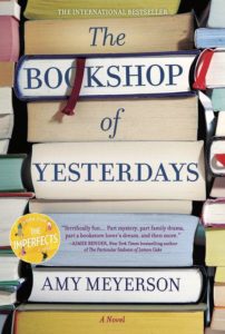 A colorful assortment of book spines, showcasing various titles with "the bookshop of yesterdays" by amy meyerson prominently displayed in the center as a highlighted novel.