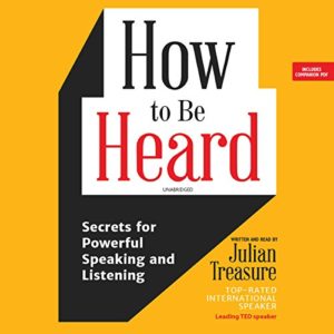 The image displays the cover of an audiobook titled "how to be heard: secrets for powerful speaking and listening" by julian treasure, who is noted as a top-rated international speaker and leading ted speaker. the cover features a striking contrast of yellow and black colors, with the title dominating the space. a white, angled speech bubble graphic intersects the title, suggesting the theme of voice and communication. the cover also mentions that it includes a companion pdf.