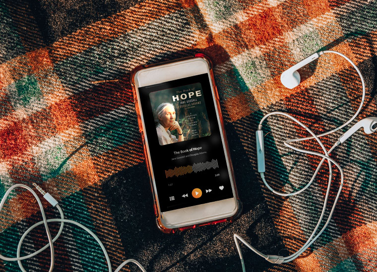 Book of hope audio book on a phone on a plaid, fall-inspired blanket
