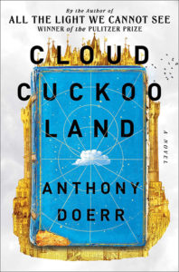 Cover of the novel "cloud cuckoo land" by anthony doerr, featuring a stylized book with a bird and celestial designs on a vibrant blue background.