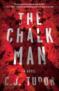 Cover of "the chalk man," a novel by c.j. tudor, featuring vibrant red autumn leaves as the background.