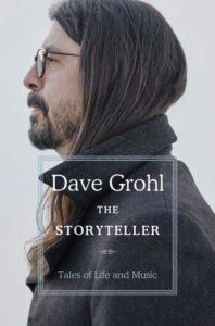 A man with shoulder-length hair and sunglasses gazes into the distance, overlaid with text "dave grohl the storyteller - tales of life and music".