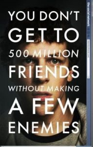 A promotional movie poster featuring a close-up of a character's intense gaze with the text "you don't get to 500 million friends without making a few enemies.